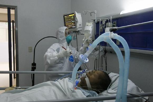 Médico suministra medicamento a paciente con respirador 